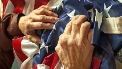 close up of hands holding American flag