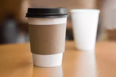 White paper coffee cup with black lid
