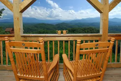 Chairs on the deck with incredible view at A Starry Night, one of our Pigeon Forge mountain cabins.