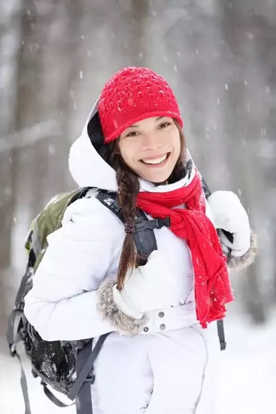 Woman hiking in layers of clothes with a backpack