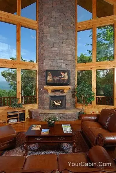 living room of log cabin with views of blue sky