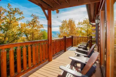 smoky mountain cabin deck with chairs looking out at the woods