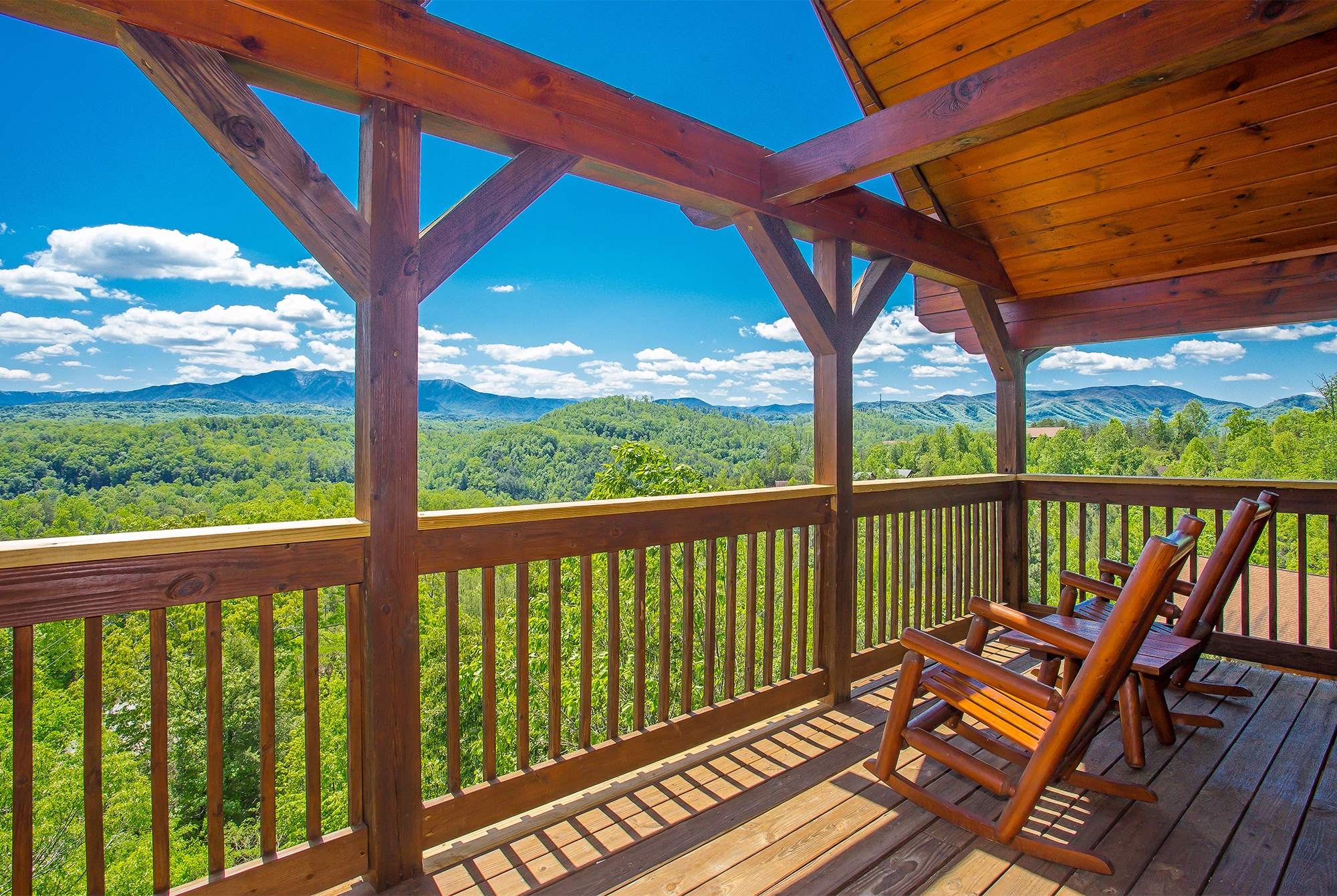 chairs on cabin porch with beautiful mountain view