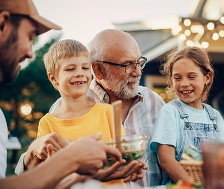 family smiling at a cookout