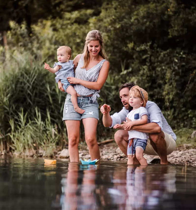 parents with children playing in shallow water