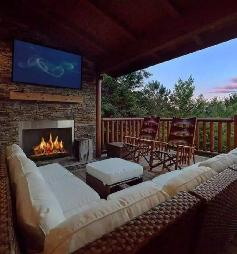 fireplace and outdoor furniture on cabin deck