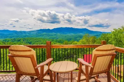 two chairs on the deck of a honeymoon cabin in Gatlinburg