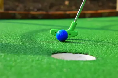 mini golf putter taking a shot 