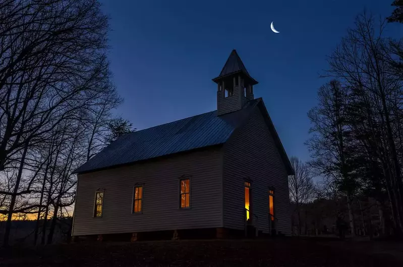 Cades Cove church at night with lights on