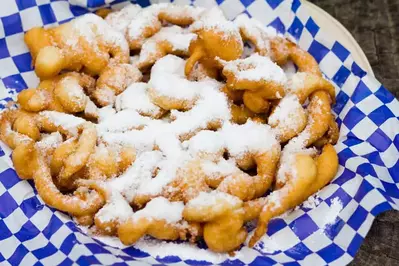 funnel cake topped with powdered sugar 