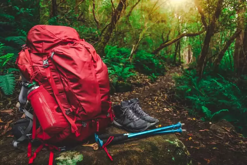 hiking backpack and supplies on a trail