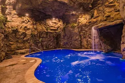 pool at cave mountain lodge with blue light and waterfall