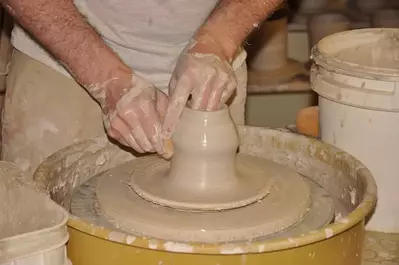 person making pottery