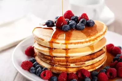 stack of pancakes with blueberries and raspberries