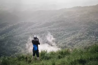 person taking pictures of the mountains