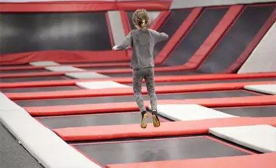 kid jumping in trampoline park