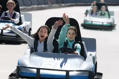 two girls riding go karts