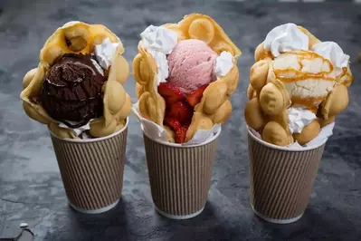 Delicious bubble waffles with ice cream in cups.