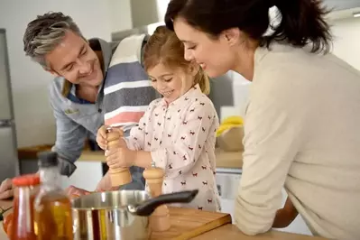 family cooking in kitchen