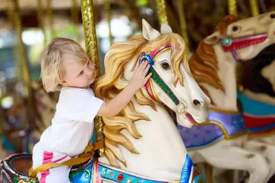 kid on carousel