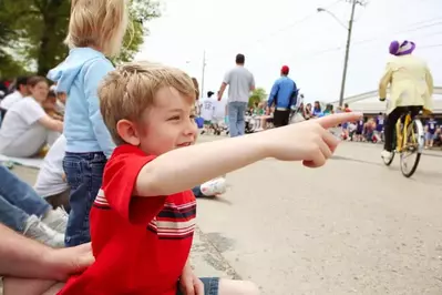 A boy watching a parade.