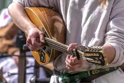 Someone playing an Irish folk instrument.