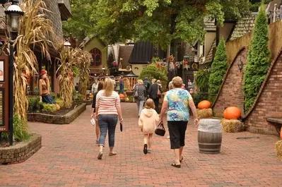 A family strolling through The Village Shops in Gatlinburg.