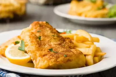 A plate of fish and chips in a restaurant.