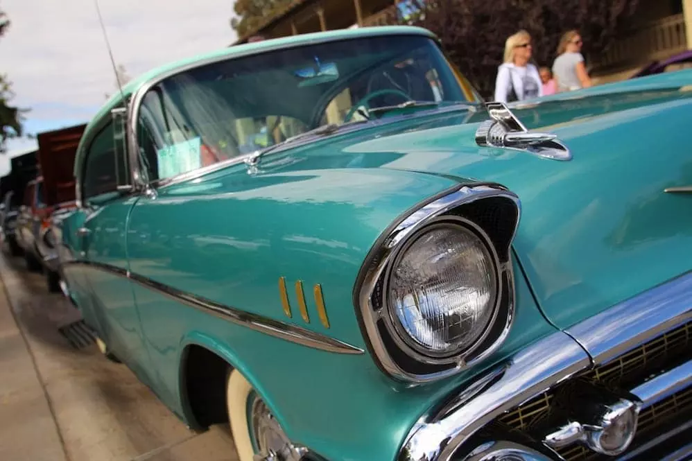 A vintage blue car at a show.