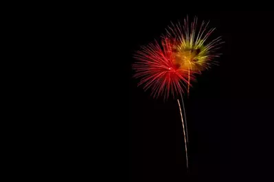 Red and yellow fireworks in the sky celebrating New Year's Eve in Gatlinburg TN.