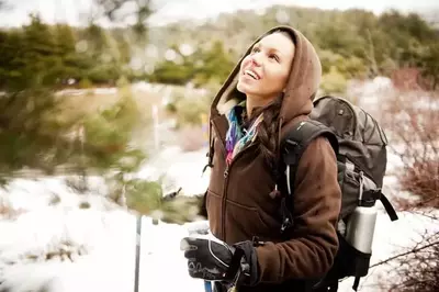 Woman taking a winter hike.