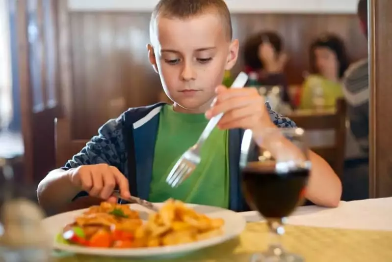 Boy eating lunch at a restaurant.