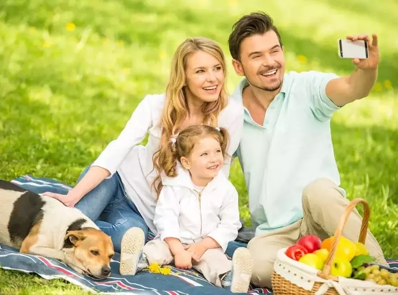 Happy family taking a selfie at a picnic near our luxury cabin rentals in Gatlinburg.