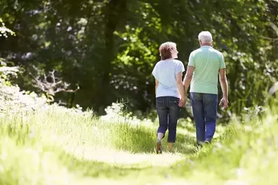 Couple walking in the woods near our Pigeon Forge mountain cabins.