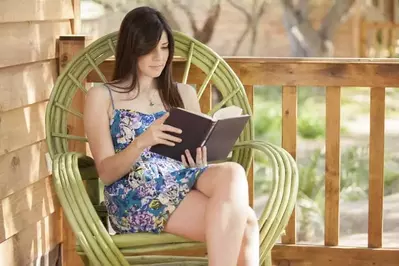 Woman reading a book at one of our 4 bedroom cabins for rent in Gatlinburg TN.