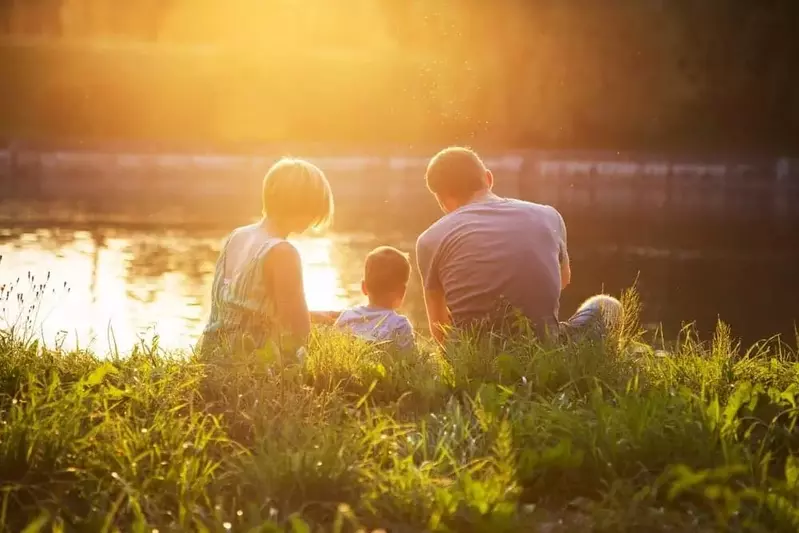 Family relaxing by the river near our 4 bedroom cabins for rent in Gatlinburg TN.