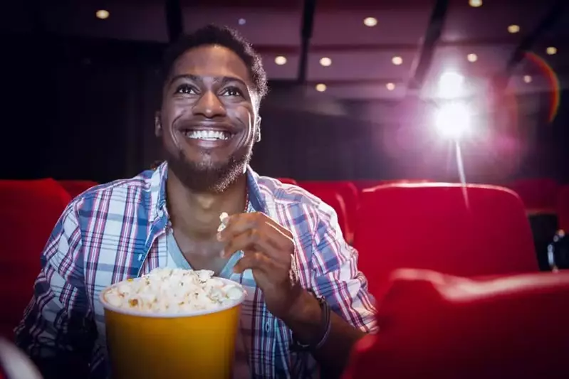man enjoying popcorn in theater room