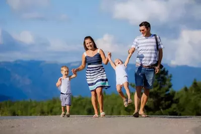 family walking with Great Smoky Mountains in the background