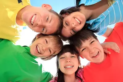 Five kids smiling at the camera having fun in Pigoen Forge