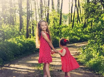 Sisters walking in the woods on their Pigeon Forge cabin vacation.