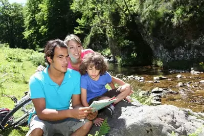 Family sitting by a river in Gatlinburg mountains