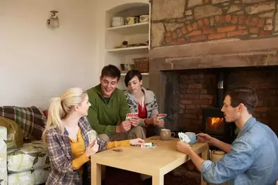 Family playing a game at the table in a Pigeon Forge group cabin