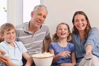 Family watching movie from couch