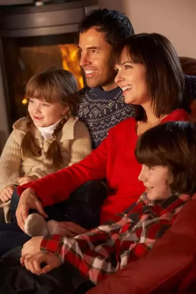 Family relaxing by the fireplace