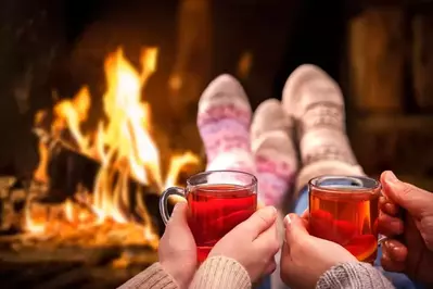 Couple relaxing by the fireplace