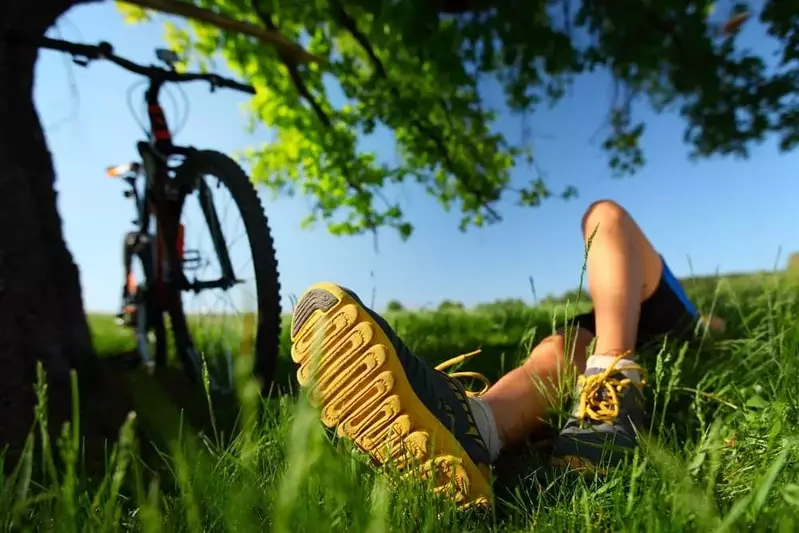 Byciclist relaxing on the grass