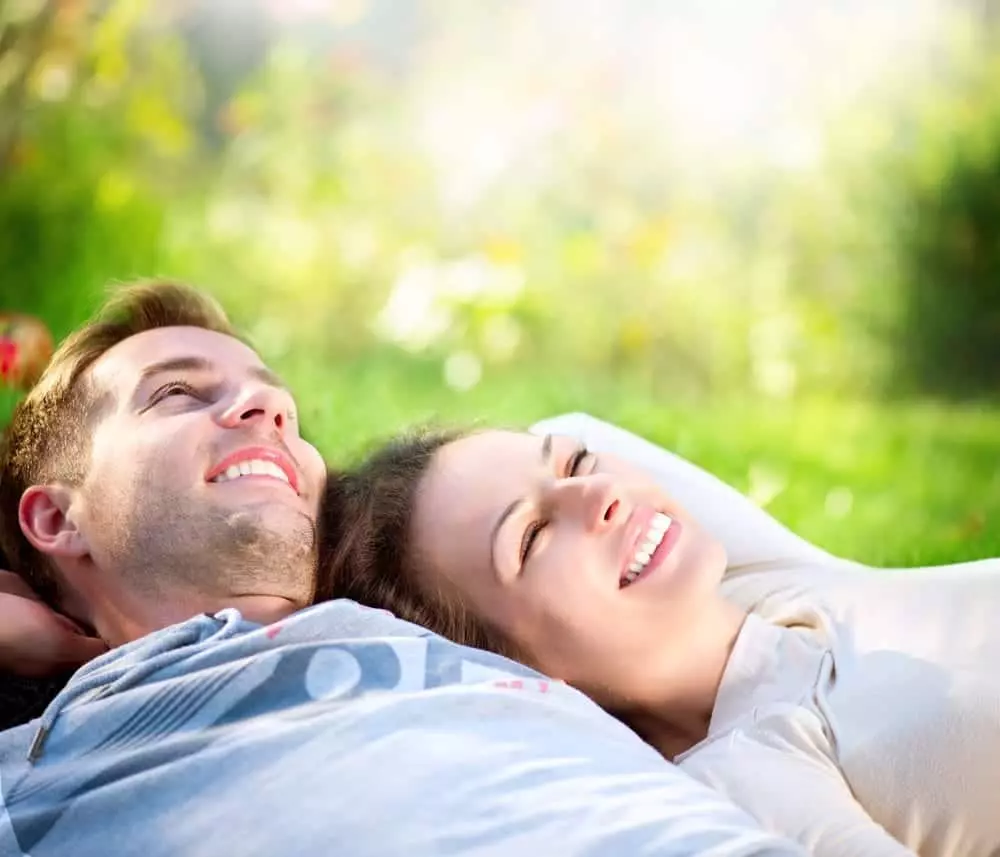 Happy couple relaxing on the grass