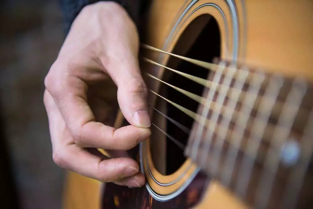 Closeup of man playing guitar