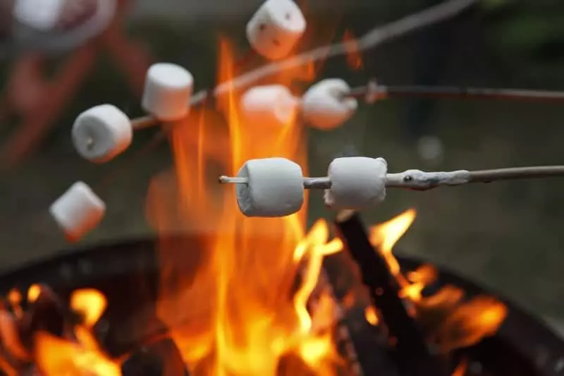Roasting marshmallows over open flame