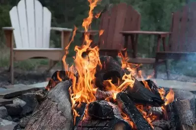 A firepit with chairs in the background